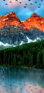 Mountain lake at sunset with birds flying in vibrant colors.