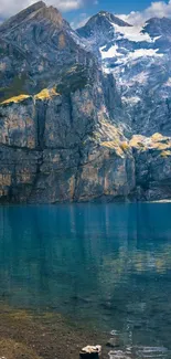 Scenic view of a mountain lake with rugged cliffs and clear blue water.