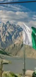 Mountain landscape with river and flags under a vibrant sky.