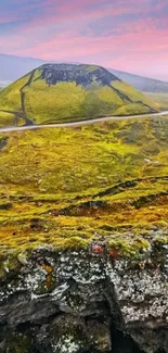 Vibrant green hills against a colorful sky in a stunning mountain landscape.