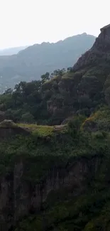 Scenic mountain landscape with green hills and cliffs.