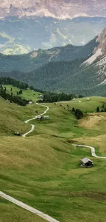 Lush green mountain valley with winding path and scenic views.