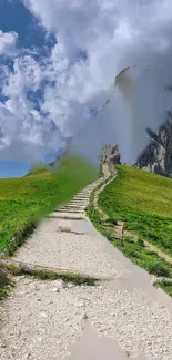 Pathway leading up a grassy hill under a bright blue sky and clouds.