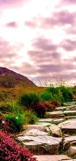 Stone path through a vibrant purple landscape with mountains and dramatic sky.