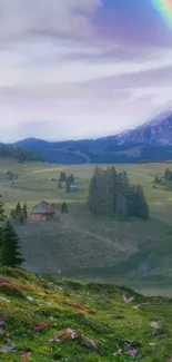 Scenic mountain landscape with a rainbow over green hills and small rustic cabins.