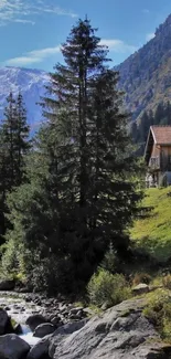 Rustic cabin by mountain stream in lush green landscape.