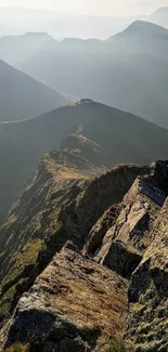 Breathtaking view of a mountain ridge with serene, misty peaks in the background.