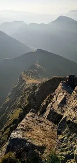 Scenic view of a rocky mountain ridge under a misty sky.