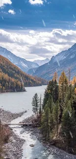 A scenic view of a mountain river with forests and a clear blue sky.