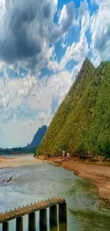 Mountain river landscape with vibrant green hills and blue sky.