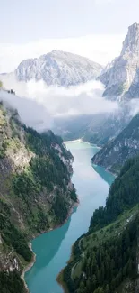 A breathtaking view of a turquoise river winding between steep, green mountains.