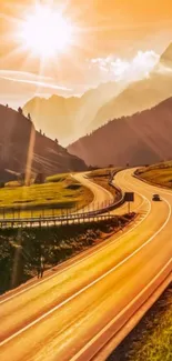 Sunset over winding mountain road with vibrant orange hues.