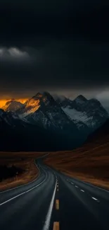 Dramatic mountain road at sunset with glowing skies and majestic peaks.