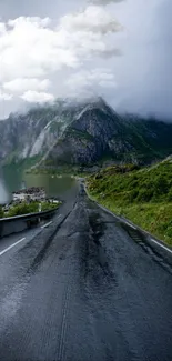 Scenic winding road through lush mountains with a cloudy sky.