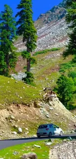 Cars on a winding road through lush green mountains.