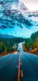 Scenic mountain road with snow-capped peaks and lush forests.