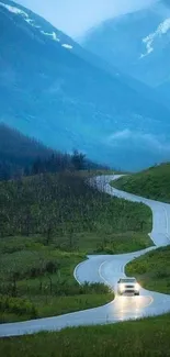 Winding mountain road with lush greenery and misty blue peaks.