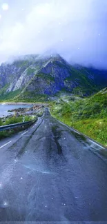 Scenic mountain road with misty peaks and lush greenery wallpaper.