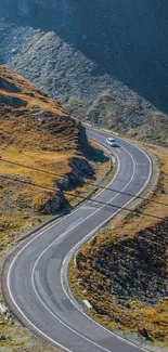 Winding road through scenic mountain landscape mobile wallpaper.