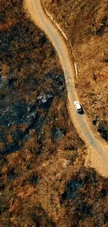 Aerial view of car on a winding mountain road.