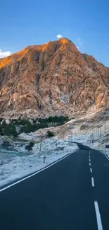 Scenic road through mountains with a blue sky.