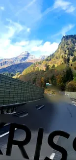 Scenic mountain road with clear blue sky.