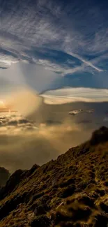 Golden sunrise over mountains with clouds and clear sky.