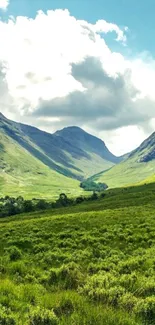 Lush green valleys under a clear blue sky in a mountain scene wallpaper.