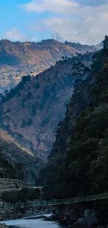 Serene mountain valley with river and lush greenery.