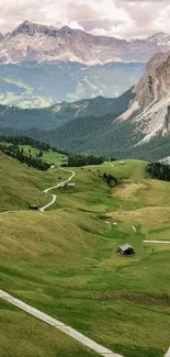 Stunning view of a lush mountain valley with winding paths and majestic peaks.