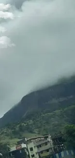 Scenic view of a misty mountain and lush landscape.