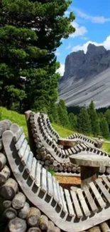 Rustic wooden benches with a scenic mountain view and lush greenery.