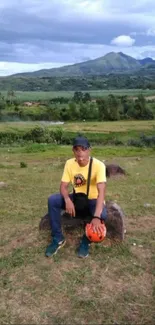 Person sitting amidst scenic mountain landscape.