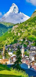 Mountain village with Matterhorn backdrop and lush green landscape.