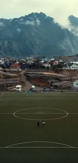 Aerial view of mountain village with football field.