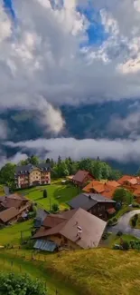 Scenic view of a mountain village with clouds and greenery.