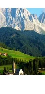 Scenic view of a mountain village with green fields and majestic peaks.