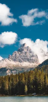 Scenic mountain and forest under blue sky.