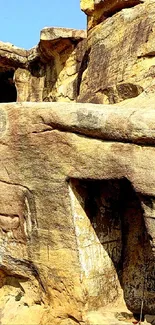 Mobile wallpaper of a scenic natural rock formation under blue skies.