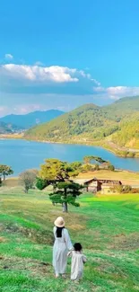 Mother and child walking in scenic landscape with lake and mountains.