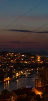Aerial night view of a city with glowing lights and a dark evening sky.