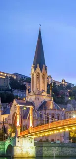 Night cityscape with church and river reflections.