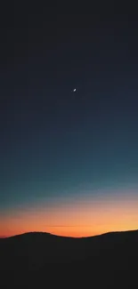 Tranquil night sky with crescent moon over hills.