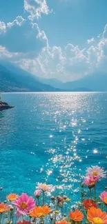 Ocean view with vibrant flowers under a clear blue sky.