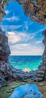 Cave opening with ocean view and clear blue sky.