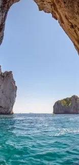 Scenic ocean cave view with turquoise waters and clear blue sky.