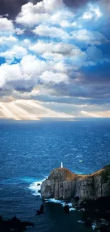 Scenic view of lighthouse by ocean under dramatic clouds and sunlight.