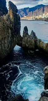 Scenic ocean view with towering rock formations and surf.