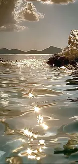 Serene ocean landscape with sunset reflecting on water.