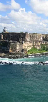 A scenic island with ocean waves and a clear blue sky.